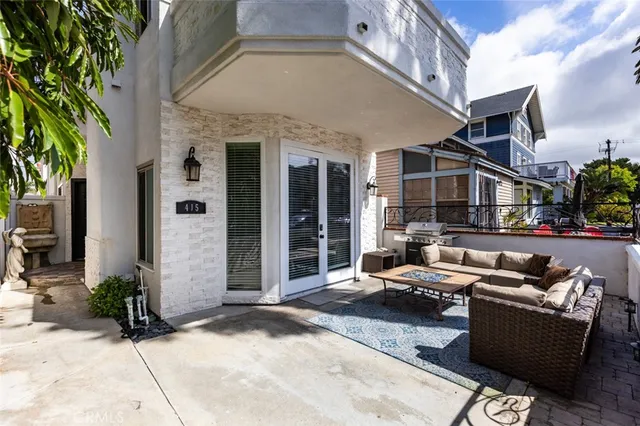 a view of a patio with couches and potted plants