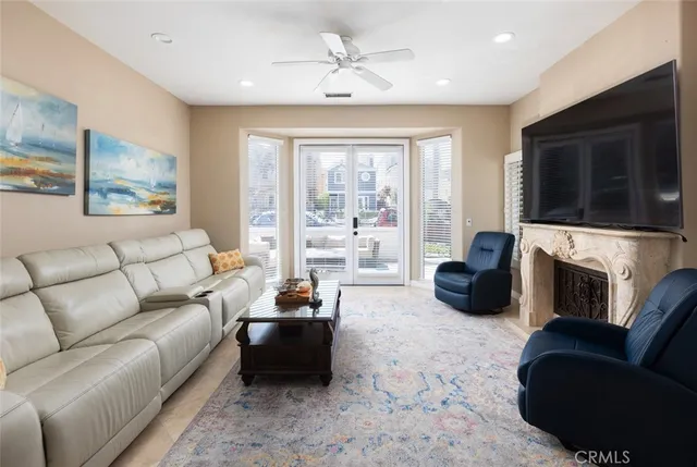 a living room with furniture a fireplace and a flat screen tv