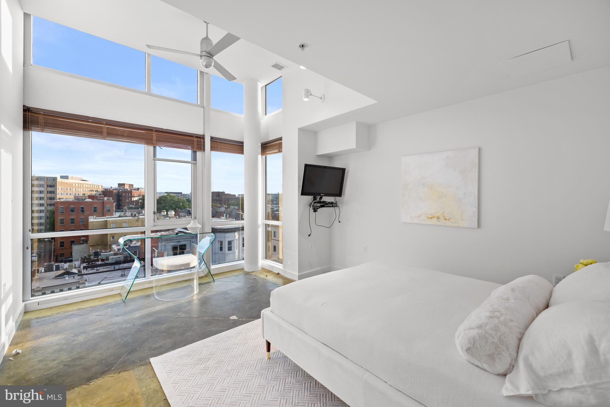 2002 Massachusetts Avenue Northwest, Unit R3 Washington, DC 20036 - Photo 21 of 27 a bedroom with a large bed and a flat tv screen