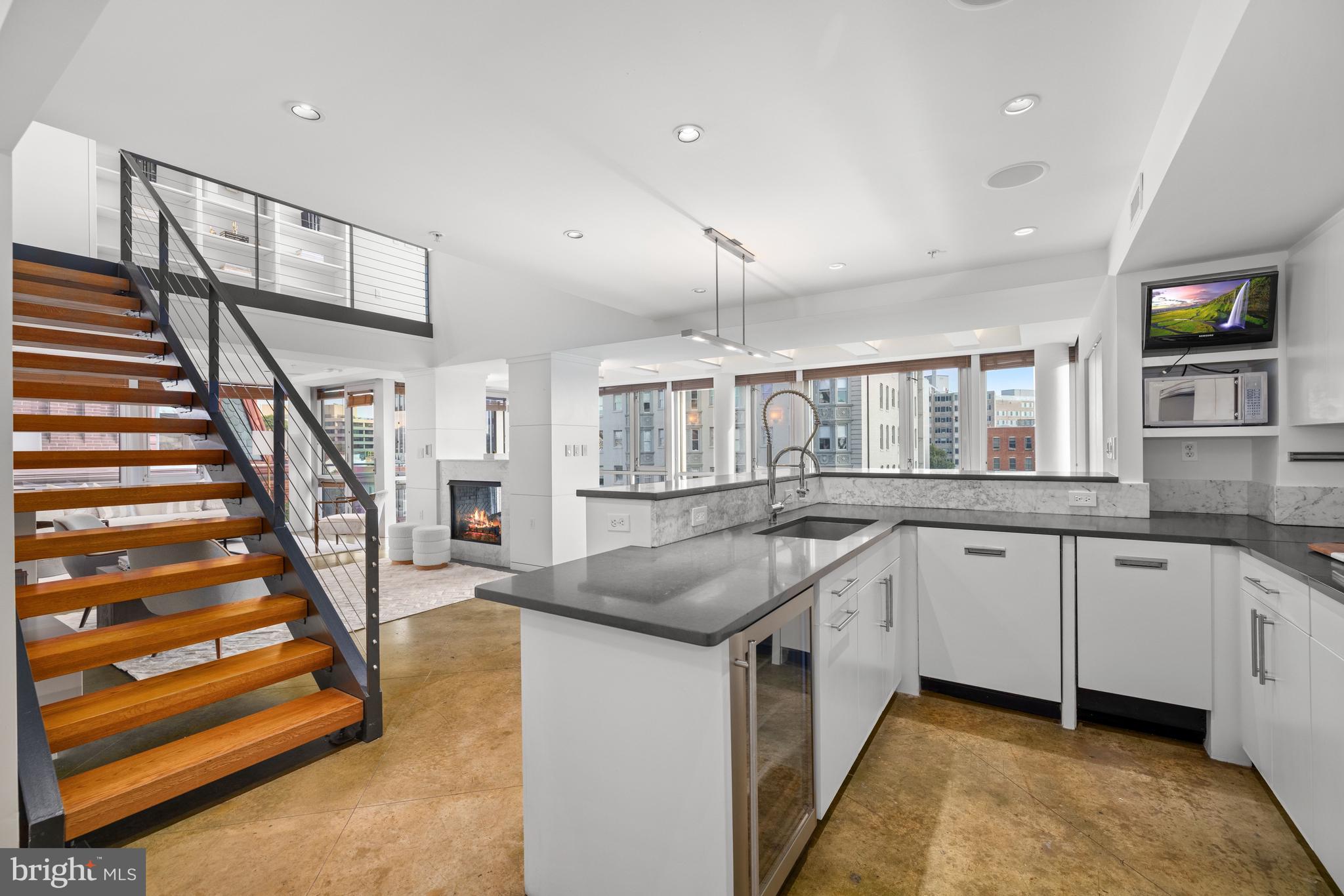 2002 Massachusetts Avenue Northwest, Unit R3 Washington, DC 20036 - Photo 3 of 27 a kitchen with granite countertop a sink and dishwasher a oven with white cabinets
