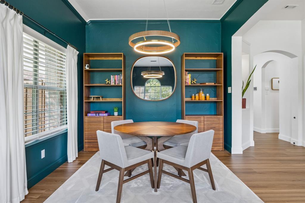 9217 Inverness Drive Rowlett, TX 75089 - Photo 4 of 40 Statement Formal Dining Space — Rich color, updated lighting, LVP flooring, and defined dining space create a memorable setting for meals, conversation, and gathering.