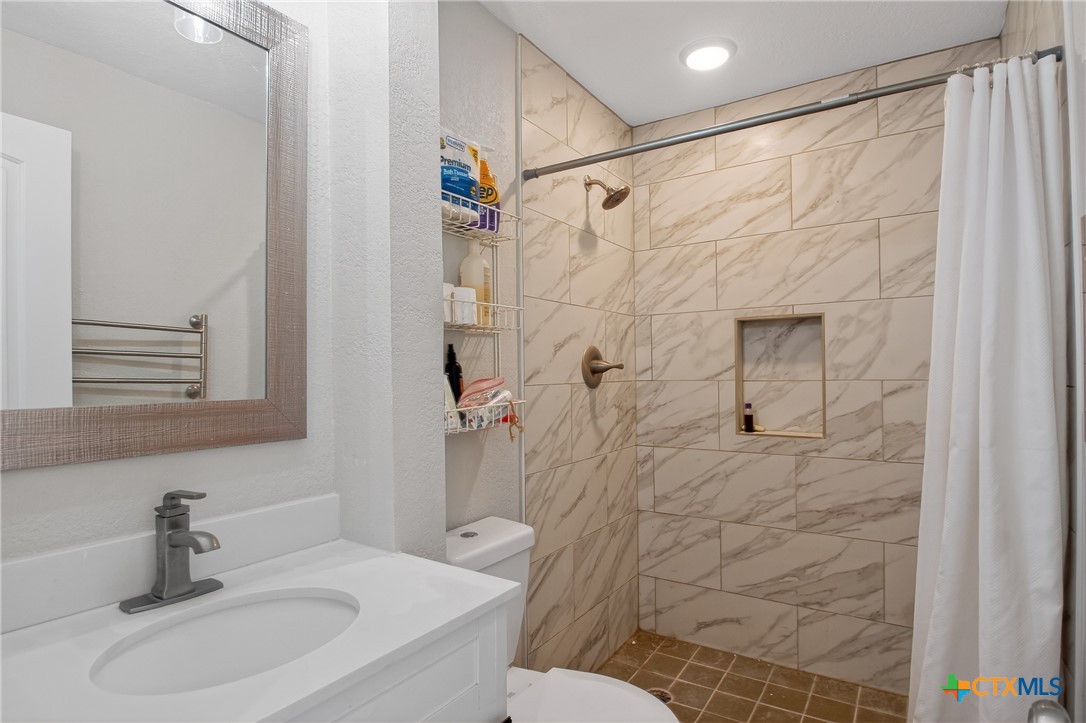 617 Bartlett Road Victoria, TX 77905 - Photo 21 of 30 a bathroom with a sink toilet and shower