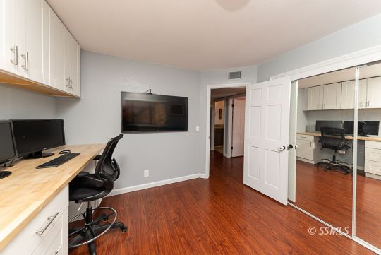 223 West Cobblestone Lane Ridgecrest, CA 93555 - Photo 20 of 34 a view of a workspace with wooden floor and bathroom