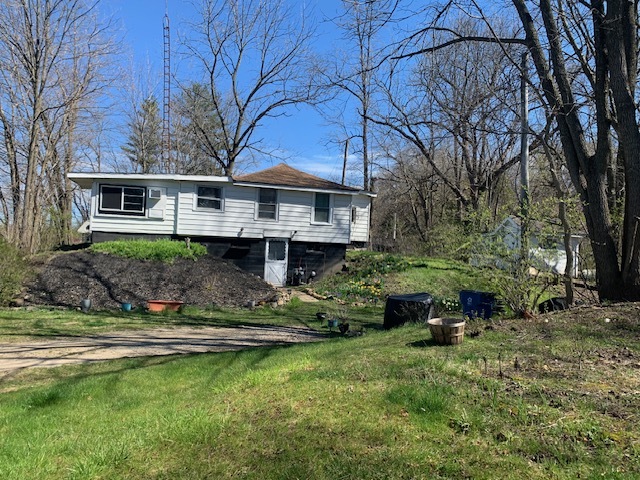 a front view of a house with a yard table and chairs