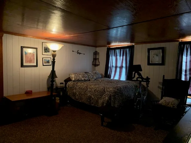 a bed sitting in a bedroom next to a window