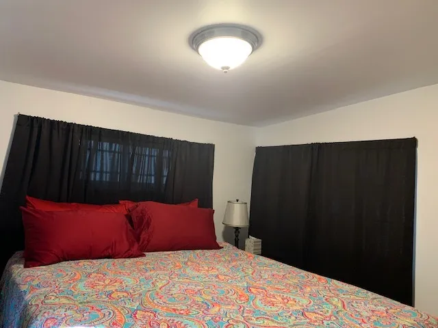 a bedroom with a bed and a black walk in closet