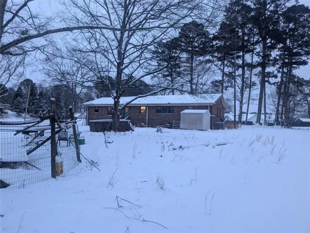 a view of a house with a yard covered in snow