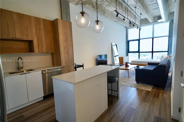 a kitchen with sink cabinets and wooden floor
