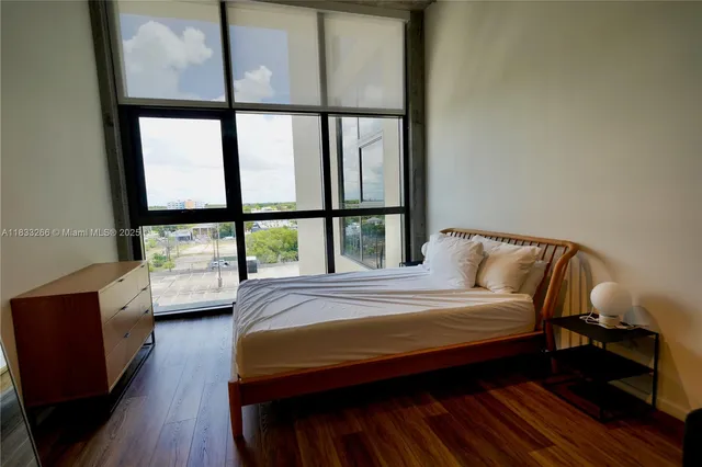 a bedroom with a bed window and a walk in closet