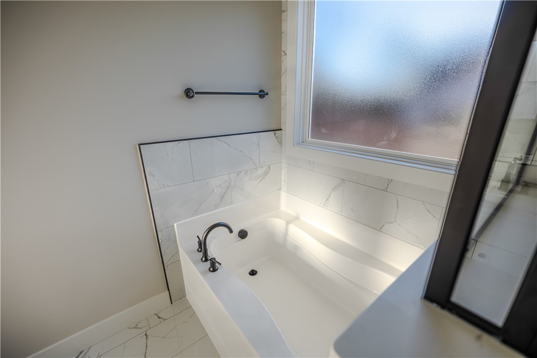 1409 Stonehurst Road Anderson, SC 29621 - Photo 15 of 37 This serene bathroom offers a soaking tub and elegant tile work.