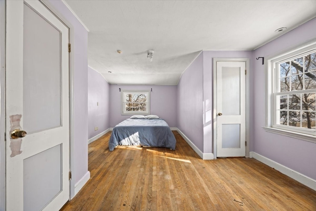 45 Dorr Street Randolph, MA 02368 - Photo 18 of 28 a spacious bedroom with a bed and a dresser