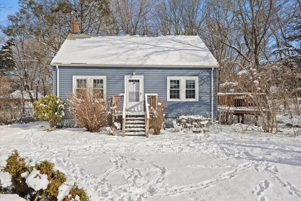 a view of a house with a yard and covered with snow