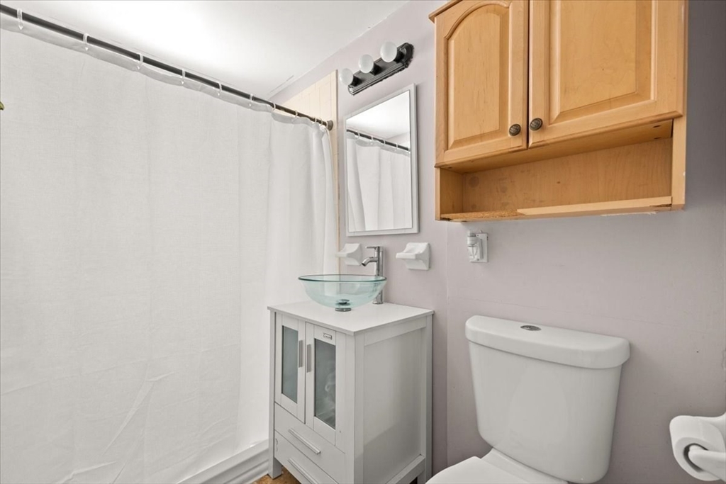 45 Dorr Street Randolph, MA 02368 - Photo 23 of 28 a bathroom with a sink a toilet and a mirror