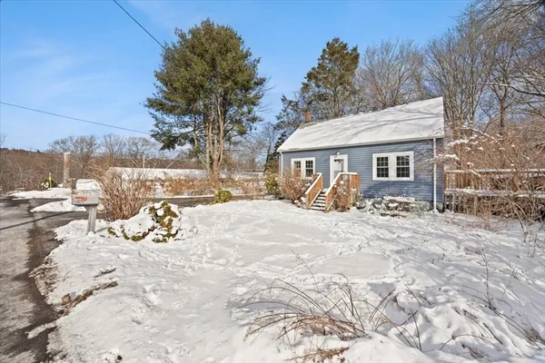 a view of a house with a yard covered in snow