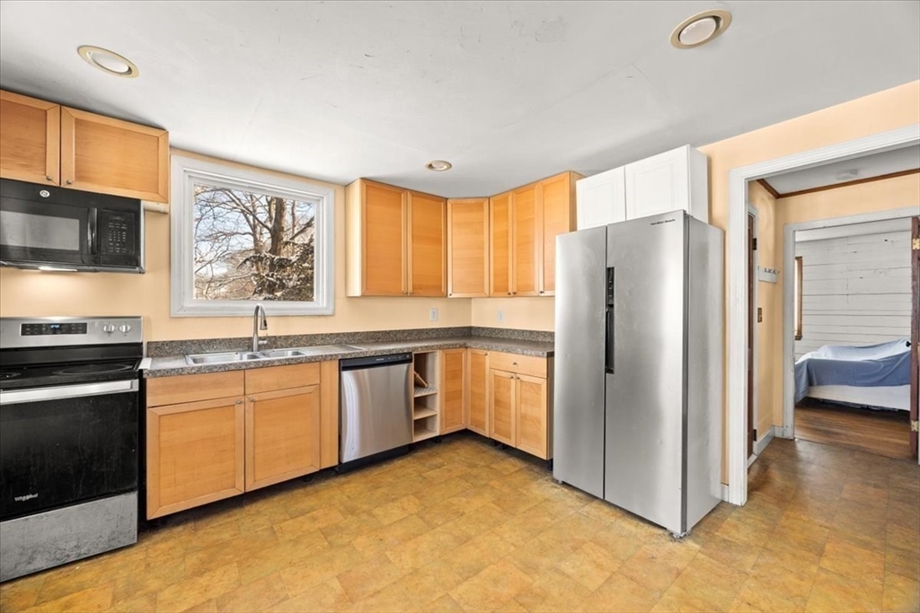 45 Dorr Street Randolph, MA 02368 - Photo 5 of 28 a kitchen with granite countertop a refrigerator and a stove top oven