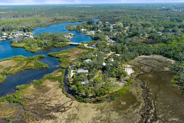an aerial view of a houses with a yard