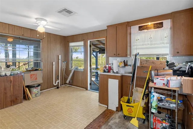 a view of a kitchen with fridge and workspace
