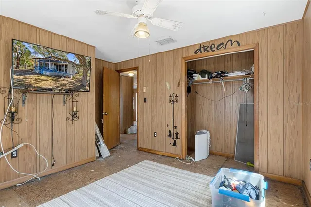 a view of a hallway with wooden floor and entryway