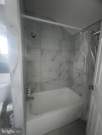 a bath tub sitting next to a white sink and vanity