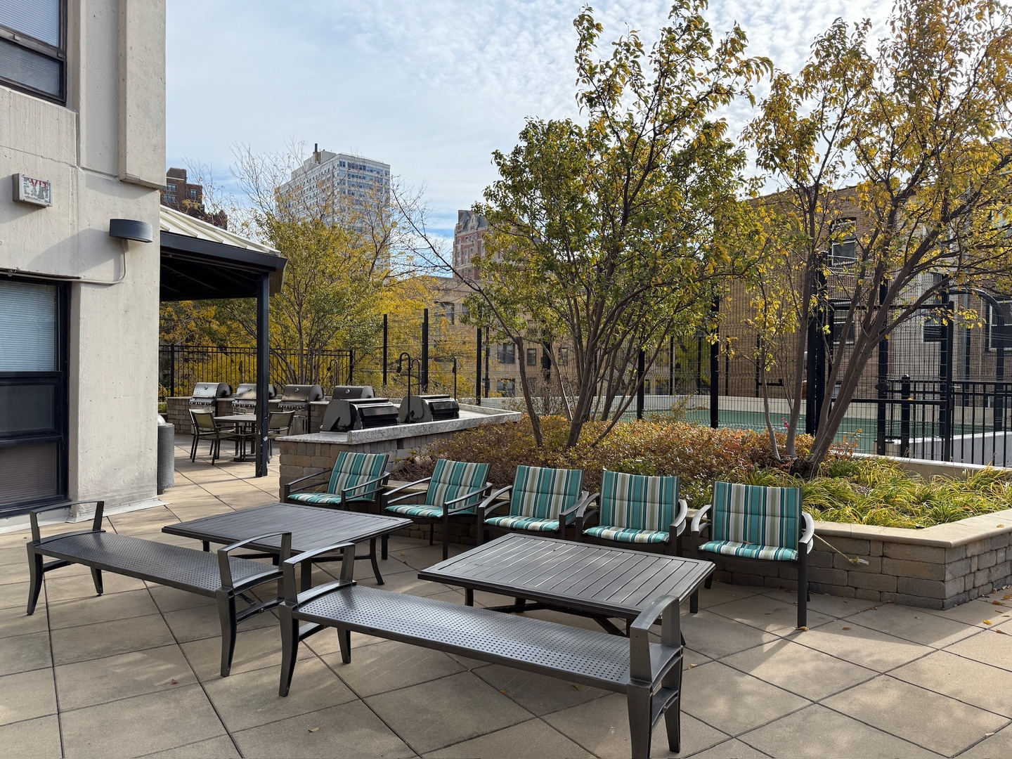 3930 North Pine Grove Avenue, Unit 1109 Chicago, IL 60613 - Photo 15 of 24 a view of a patio with couches table and chairs and potted plants