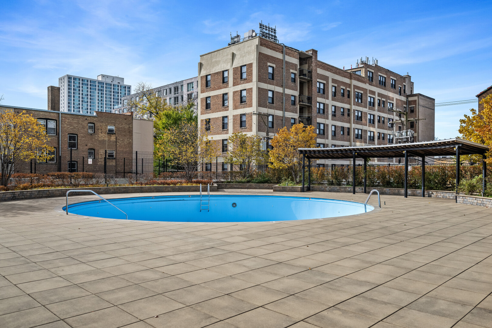3930 North Pine Grove Avenue, Unit 1109 Chicago, IL 60613 - Photo 17 of 24 a view of building with a swimming pool and outdoor space