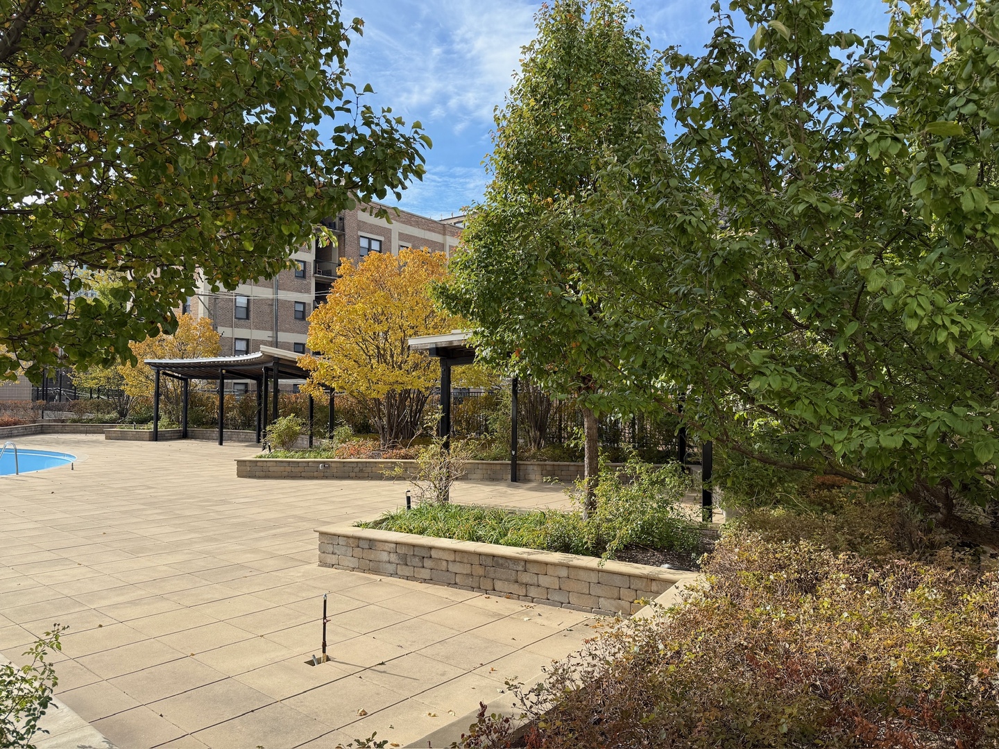 3930 North Pine Grove Avenue, Unit 1109 Chicago, IL 60613 - Photo 18 of 24 a front view of a house with a yard and fountain