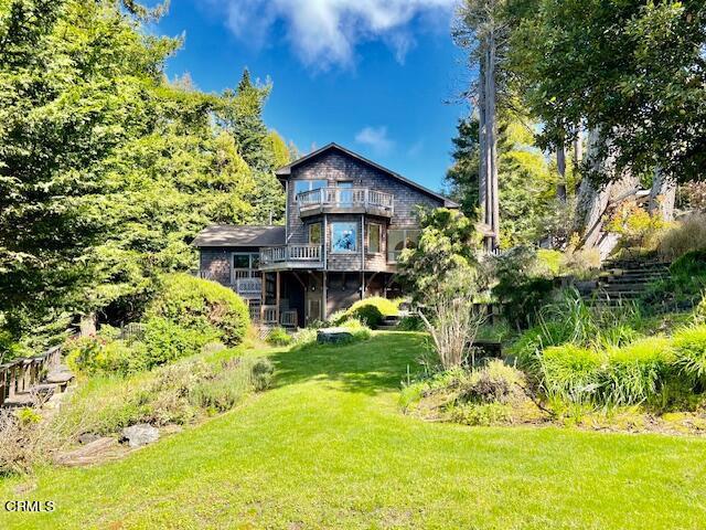 a house with a big yard and large trees