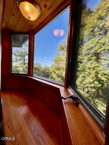a view of staircase with wooden floor and windows