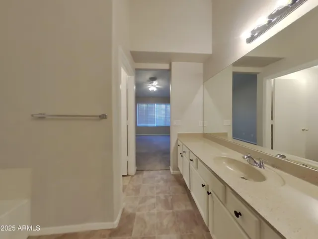 a bathroom with a double vanity sink and a mirror