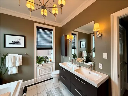 a spacious bathroom with a double vanity sink mirror and shower