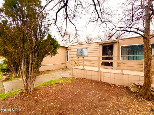 a white house that has a tree in the background