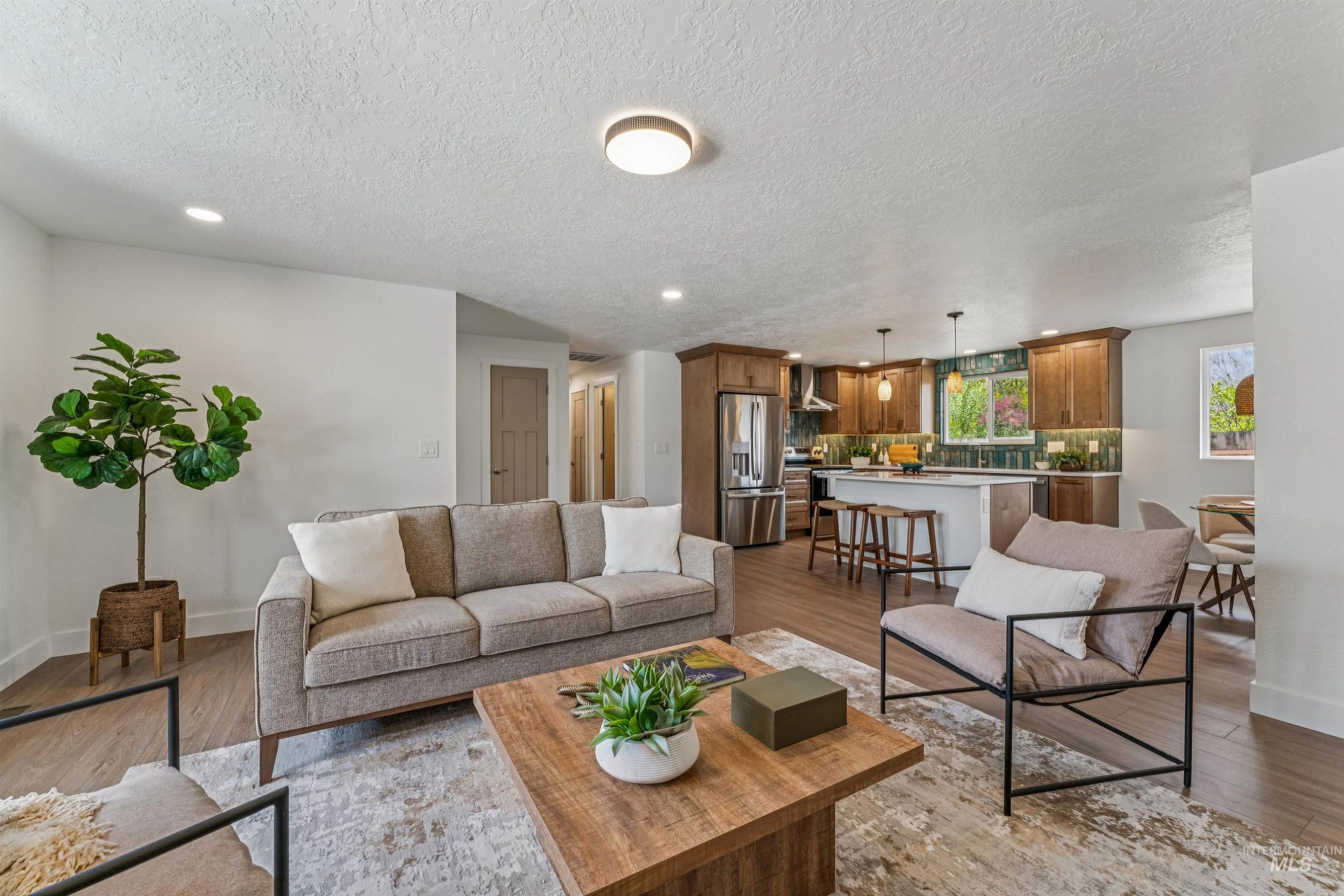 9709 West McMillan Road Boise, ID 83704 - Photo 11 of 50 Living area with light wood-type flooring, recessed lighting, and a textured ceiling