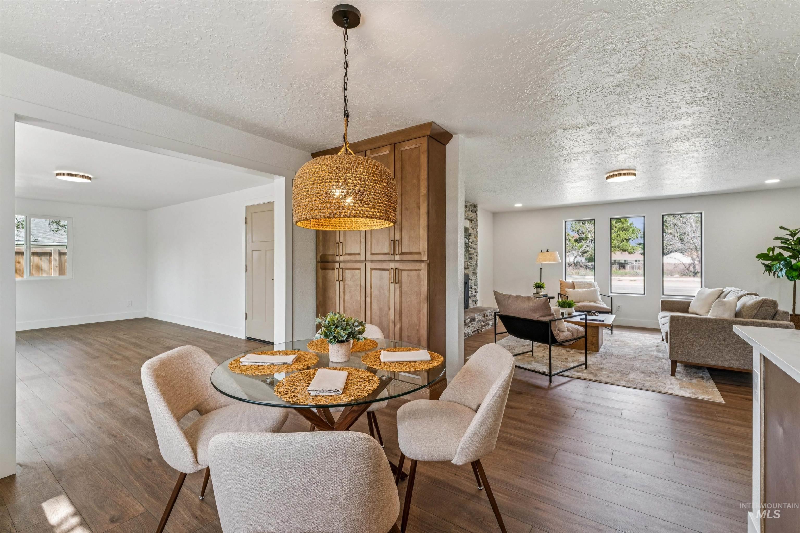 9709 West McMillan Road Boise, ID 83704 - Photo 17 of 50 Dining area featuring a textured ceiling and dark wood finished floors
