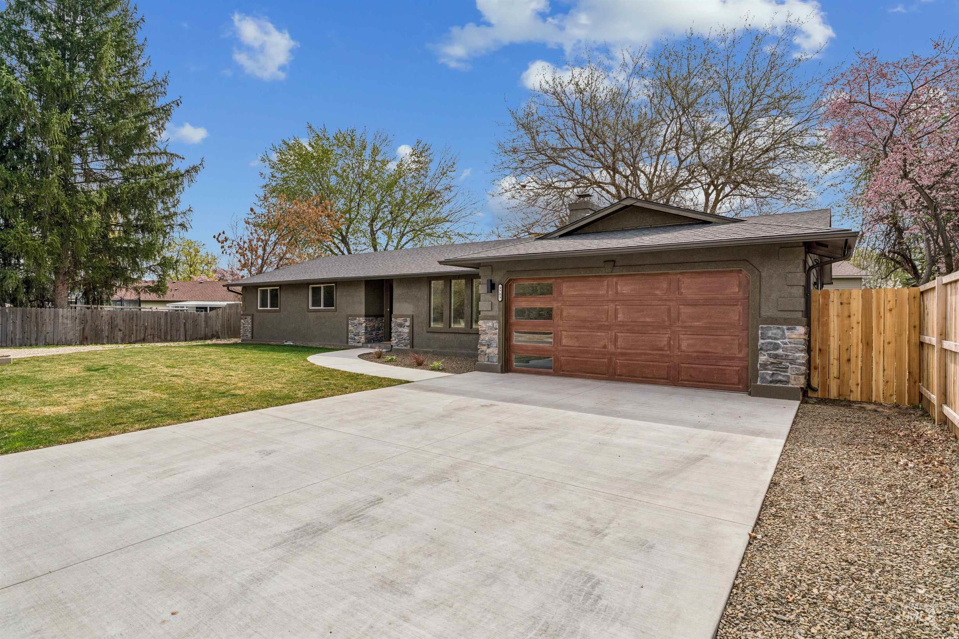 9709 West McMillan Road Boise, ID 83704 - Photo 2 of 50 Ranch-style home featuring stone siding, driveway, a chimney, an attached garage, and roof with shingles