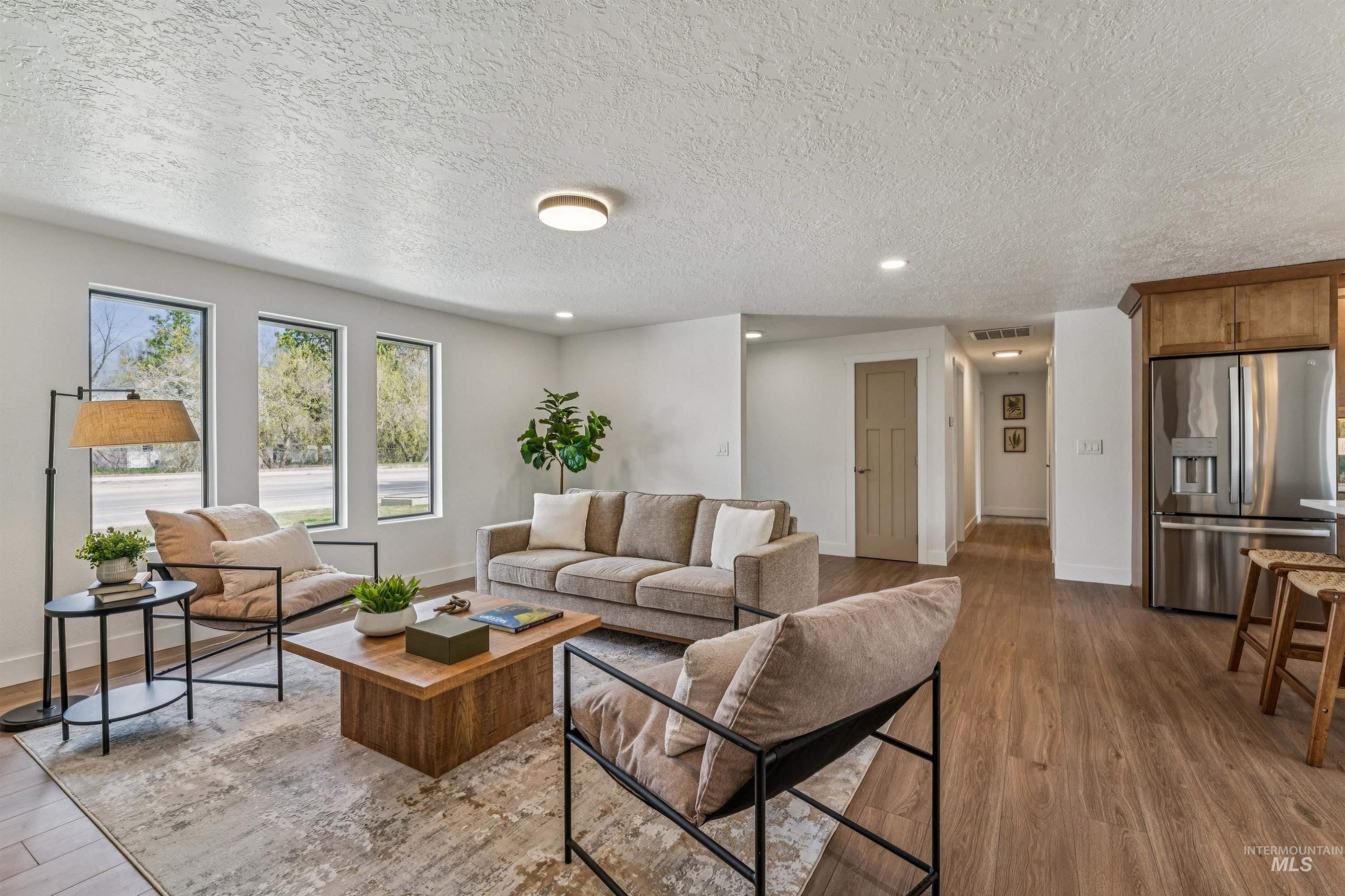 9709 West McMillan Road Boise, ID 83704 - Photo 21 of 50 Living room with recessed lighting, wood finished floors, and a textured ceiling