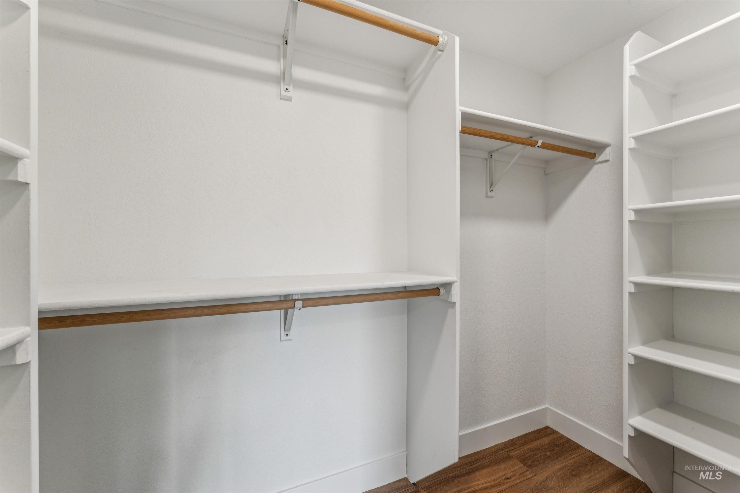 9709 West McMillan Road Boise, ID 83704 - Photo 24 of 50 Walk in closet featuring dark wood-style flooring