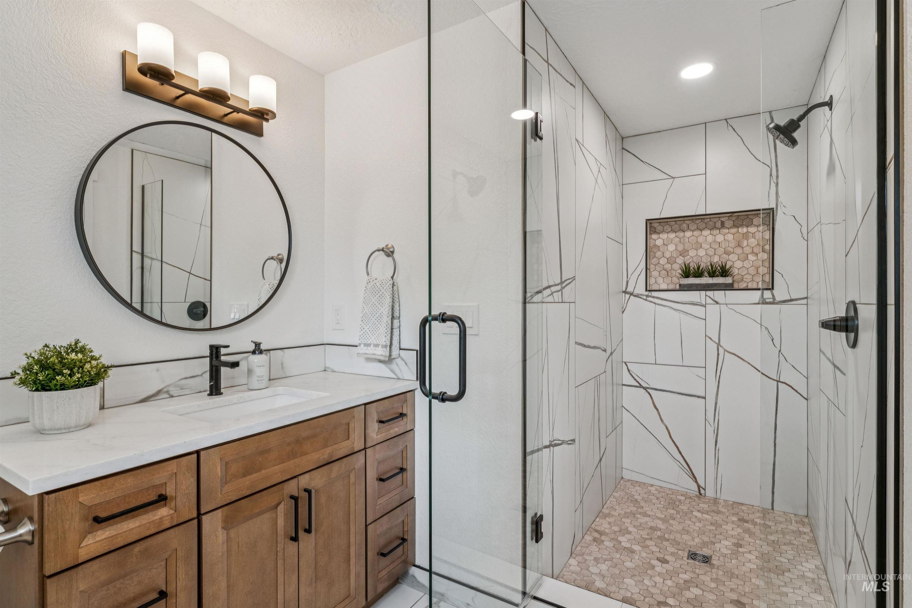 9709 West McMillan Road Boise, ID 83704 - Photo 27 of 50 Bathroom featuring vanity and a shower stall
