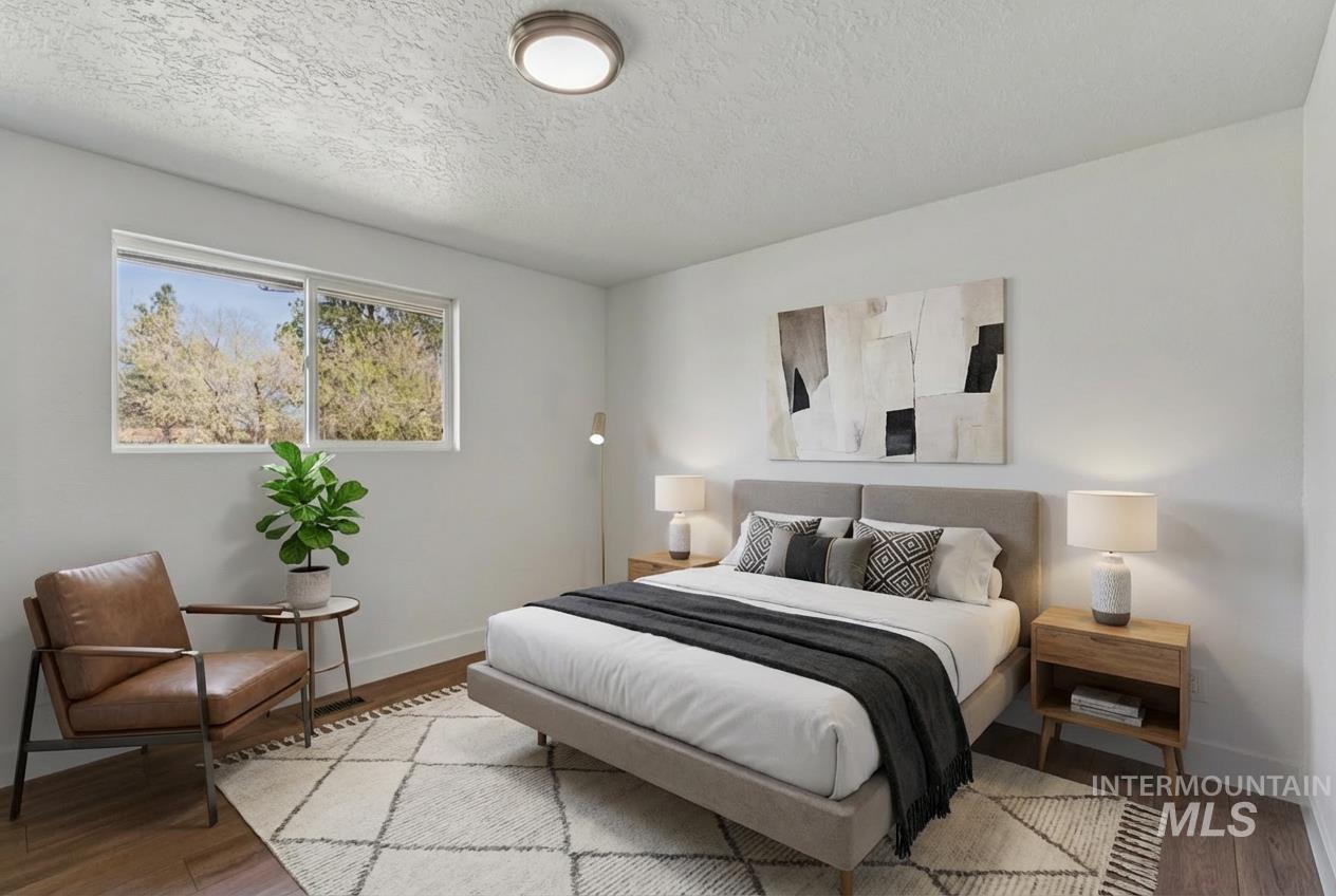 9709 West McMillan Road Boise, ID 83704 - Photo 28 of 50 Bedroom with wood finished floors and a textured ceiling