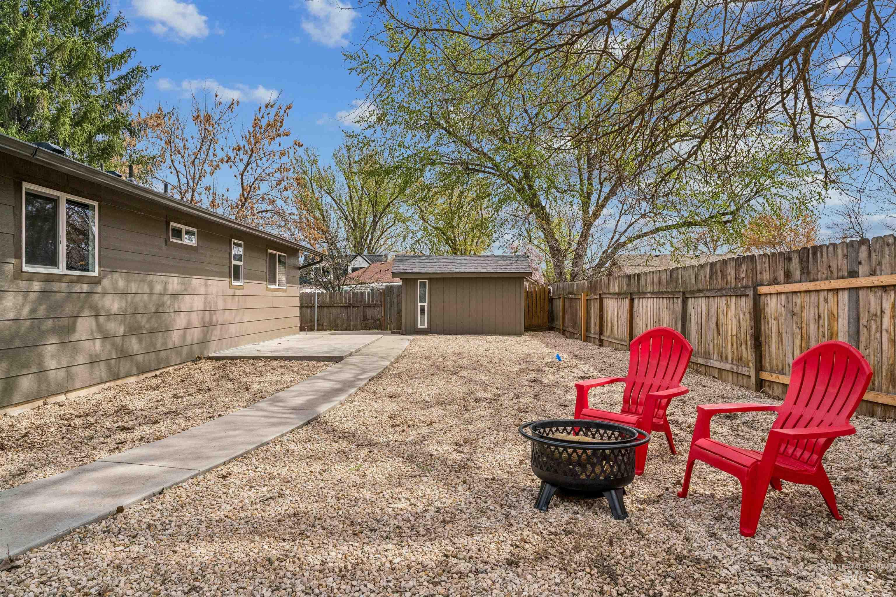 9709 West McMillan Road Boise, ID 83704 - Photo 37 of 50 Fenced backyard featuring a patio, a fire pit, and a storage shed