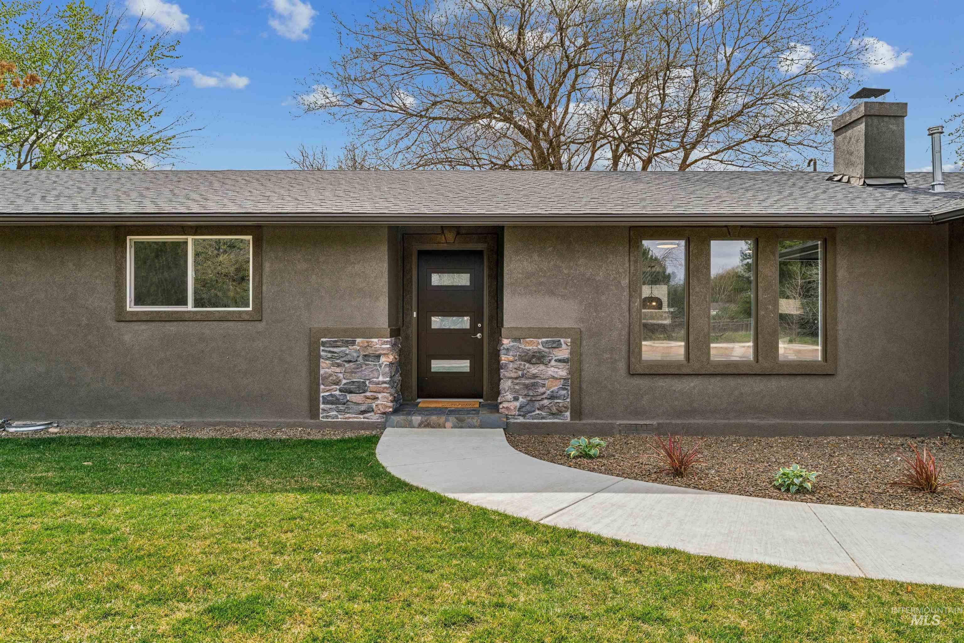 9709 West McMillan Road Boise, ID 83704 - Photo 4 of 50 View of front facade with a front yard, stucco siding, and a shingled roof