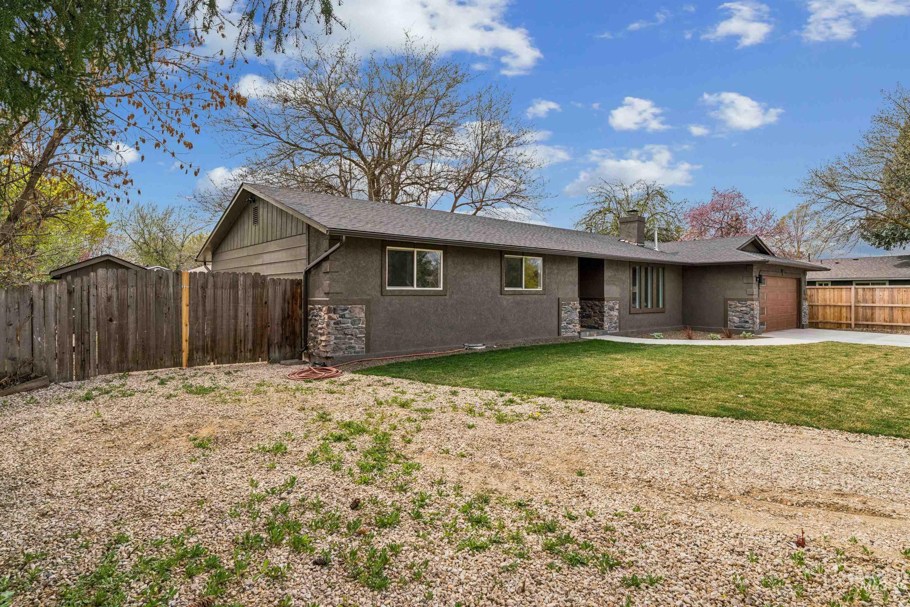 9709 West McMillan Road Boise, ID 83704 - Photo 43 of 50 Single story home featuring an attached garage, a chimney, stucco siding, concrete driveway, and stone siding