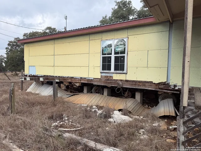 a backyard of a house with a yard and outdoor seating