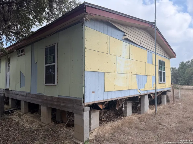 a small barn with a table and chairs