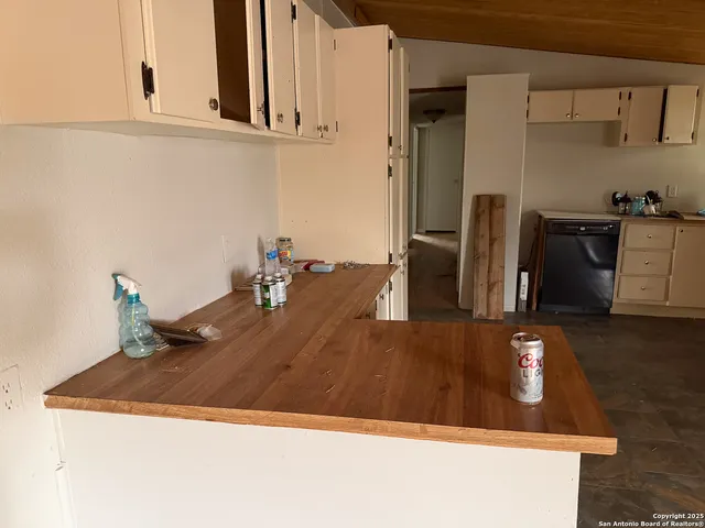 a view of kitchen island with stainless steel appliances granite countertop refrigerator sink and stove