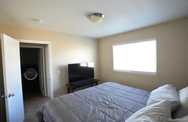 a bedroom with a bed and a television