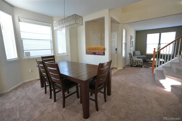 a view of a dining room with furniture and a window