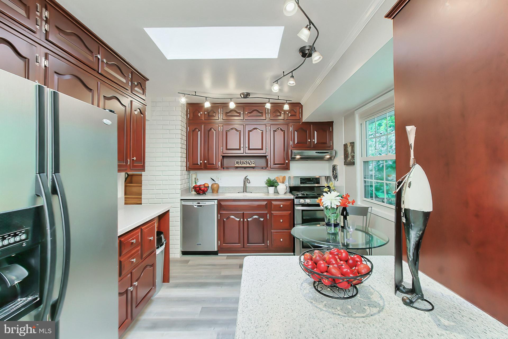 6221 Tyner Street Springfield, VA 22152 - Photo 15 of 56 Kitchen has cherry cabinets and Corian counters