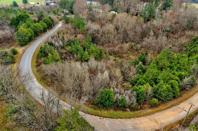 an aerial view of a houses with a yard