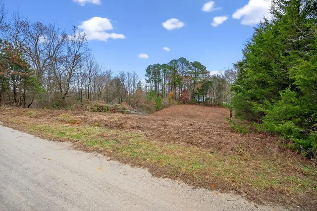 a view of a dirt road and a building
