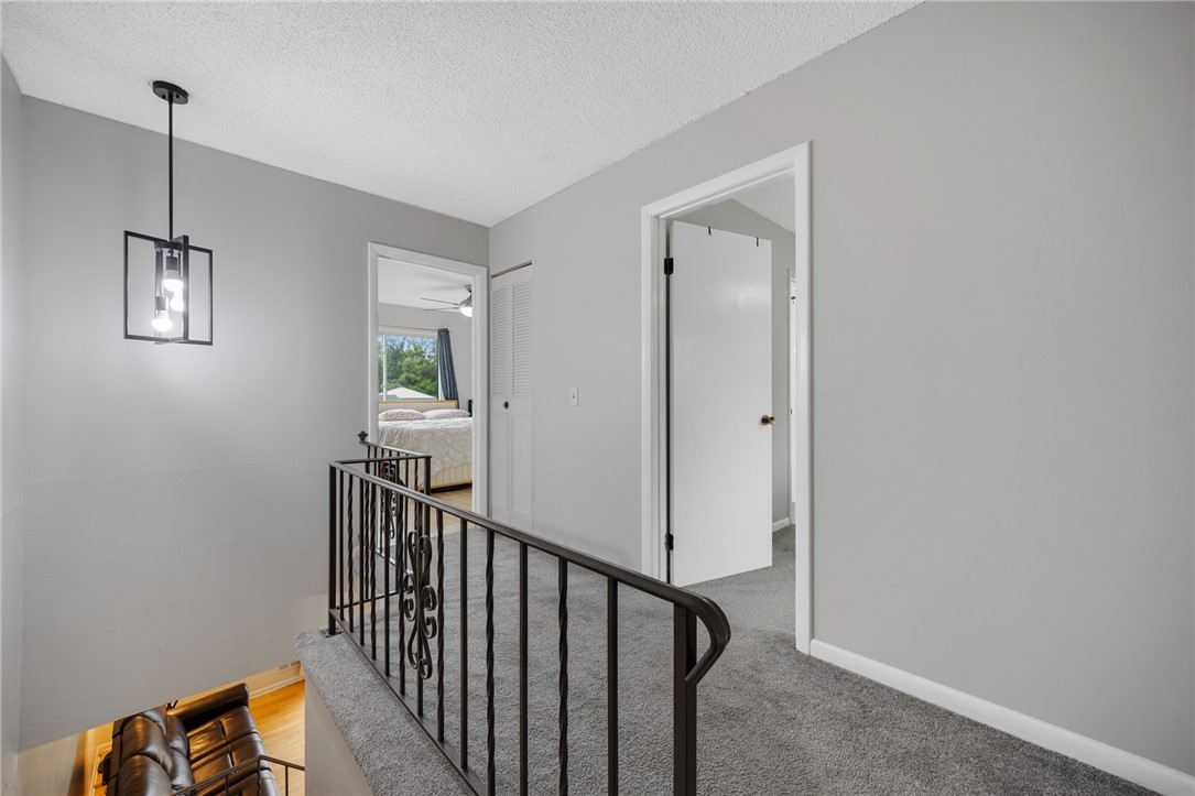 597 French Road Brighton, NY 14618 - Photo 12 of 24 Open stairway and landing contribute to the open feel of this home.